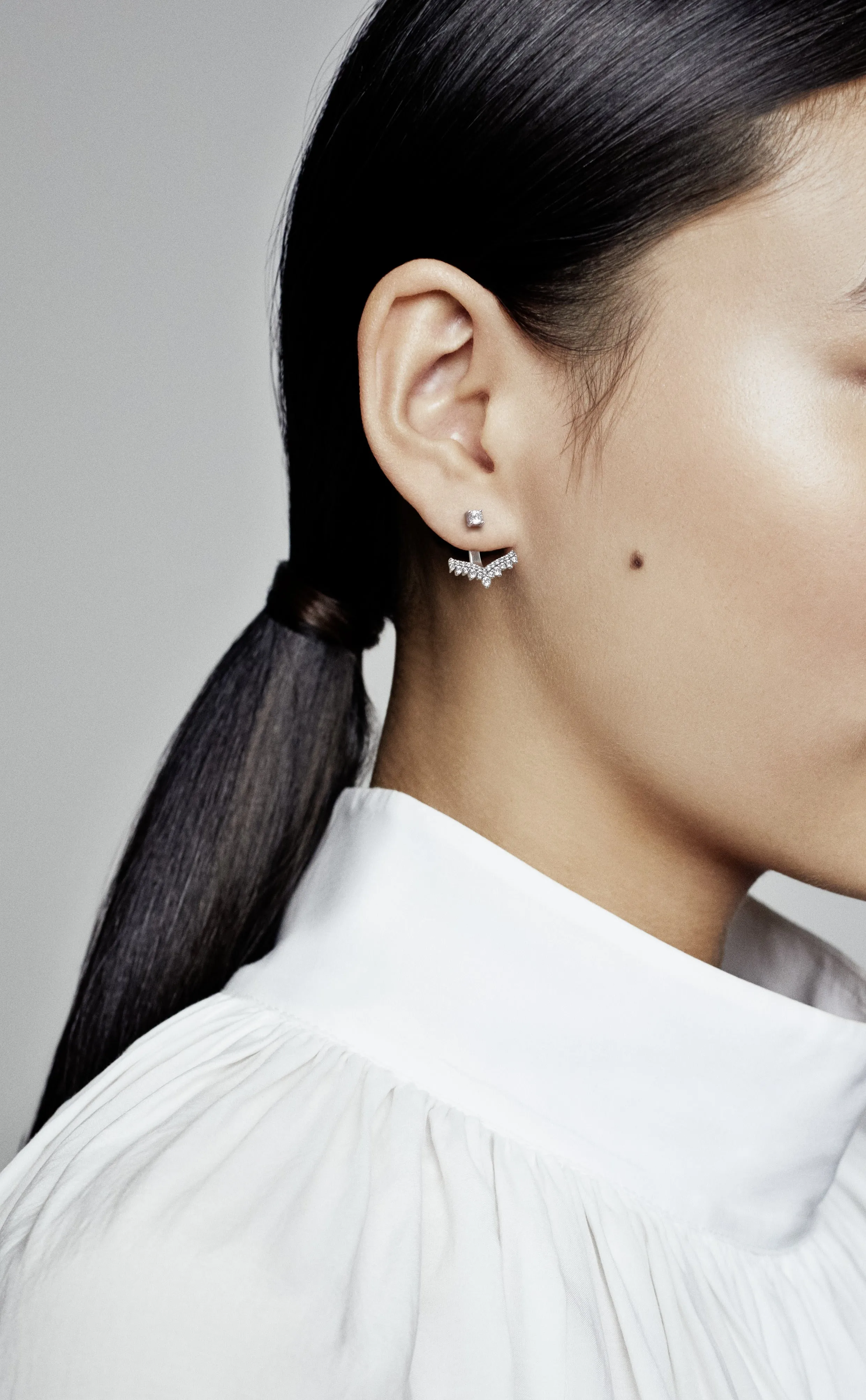 Silver stud earrings with detachable earring jackets and clear cubic zirconia